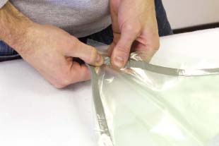 At this stage, seal 3 of the 4 edges. Press and squeeze the bagging tape very firmly to ensure an airtight seal